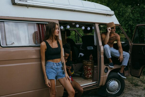 Photo by KoolShooters Friends Hanging Out by the Side of a Camper Van